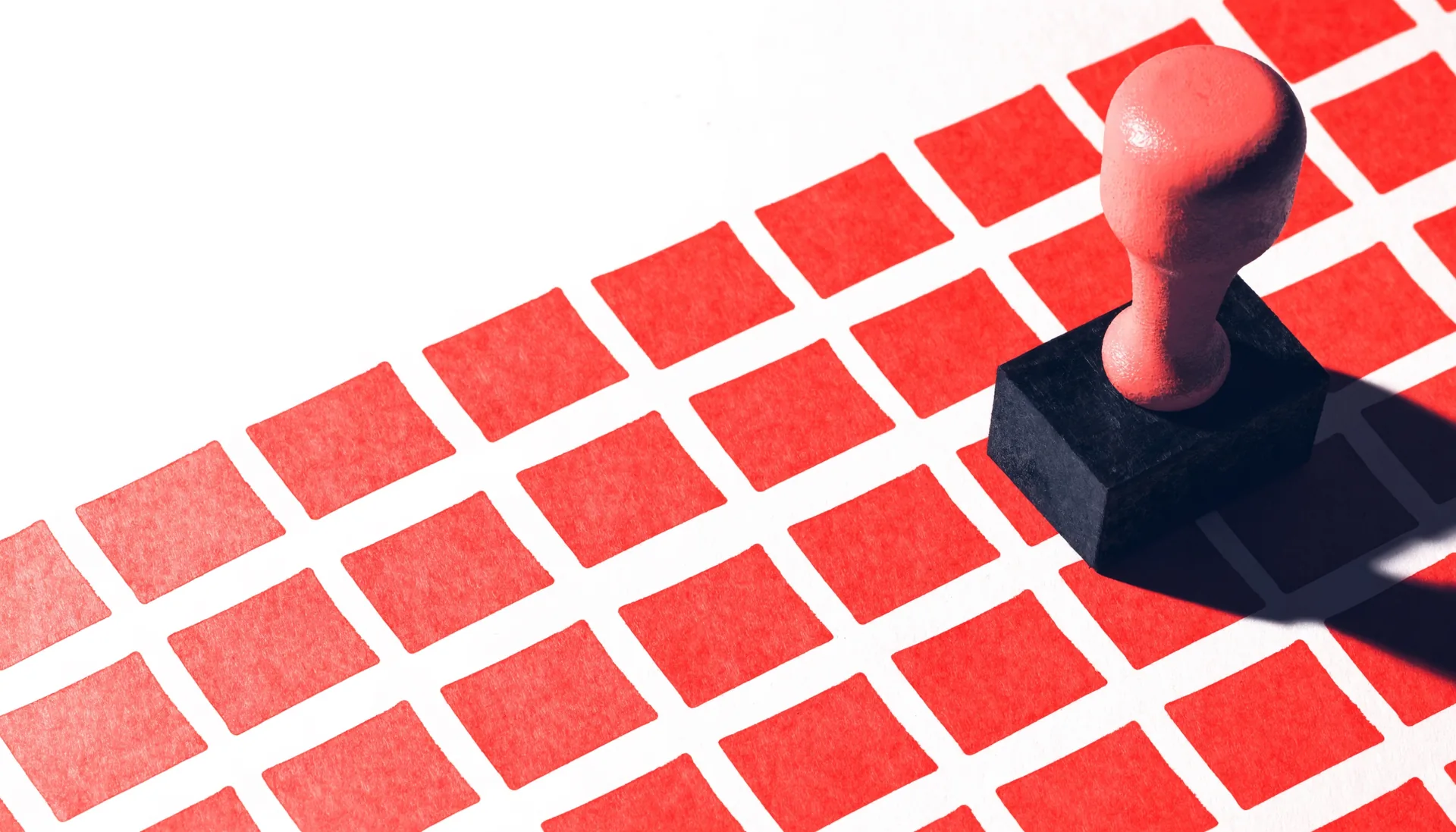 Conceptual still life: a strict grid of coral stamped impressions on an off-white sweep, with the stamp itself standing at the edge of the grid.